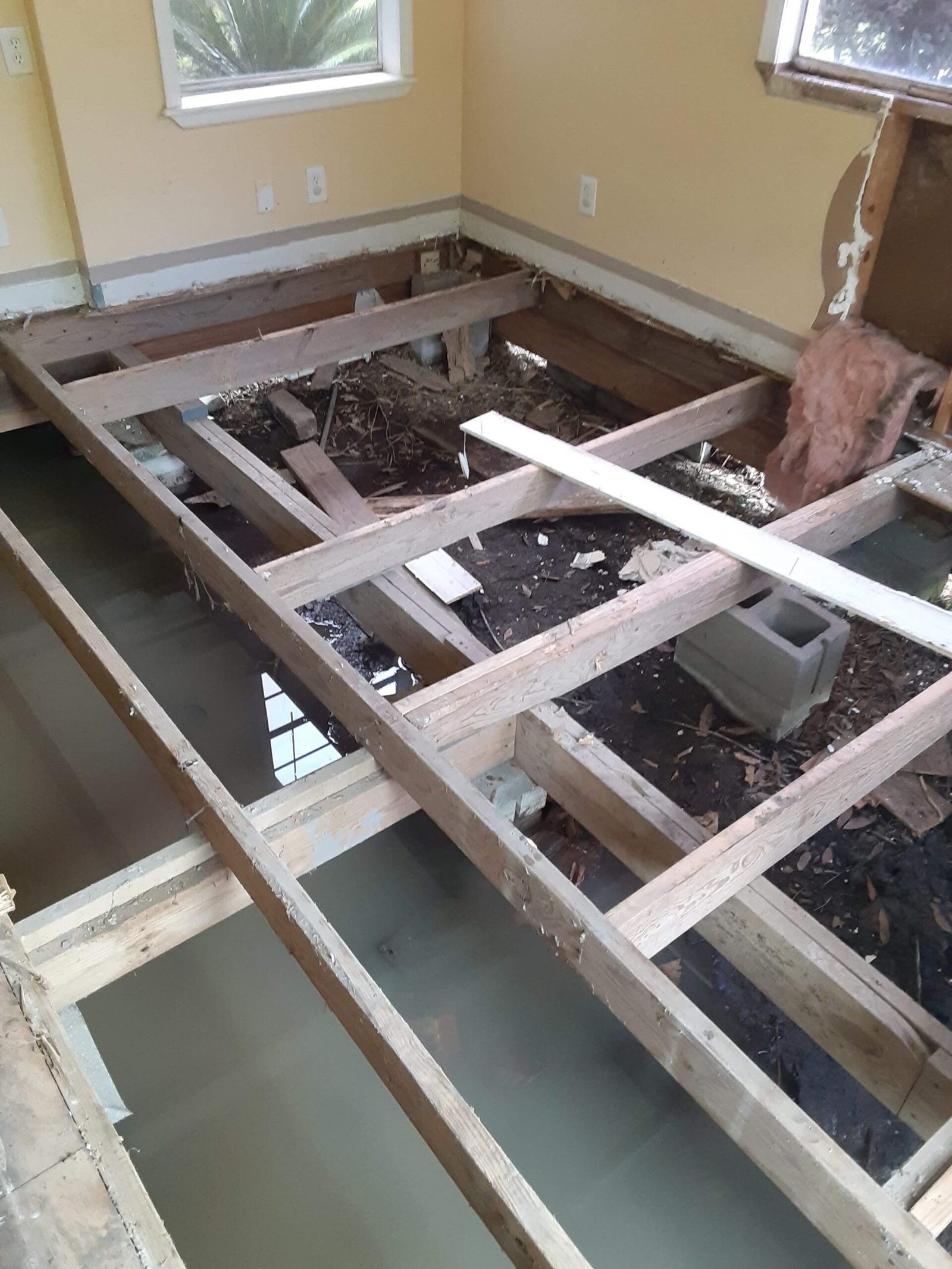 A house with the floor torn out mid-rebuild, representing how Mark Tuten approaches recovery: tearing out what is broken to build something stronger