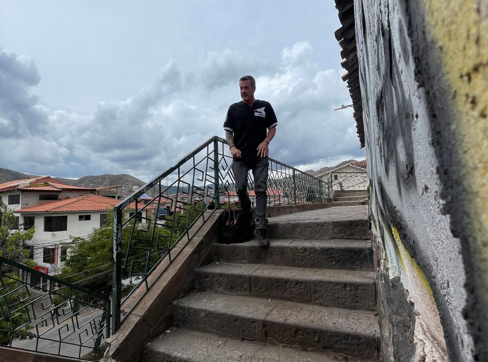 Man walking down stone steps in Peru representing the daily discipline of rebuilding life after addiction.