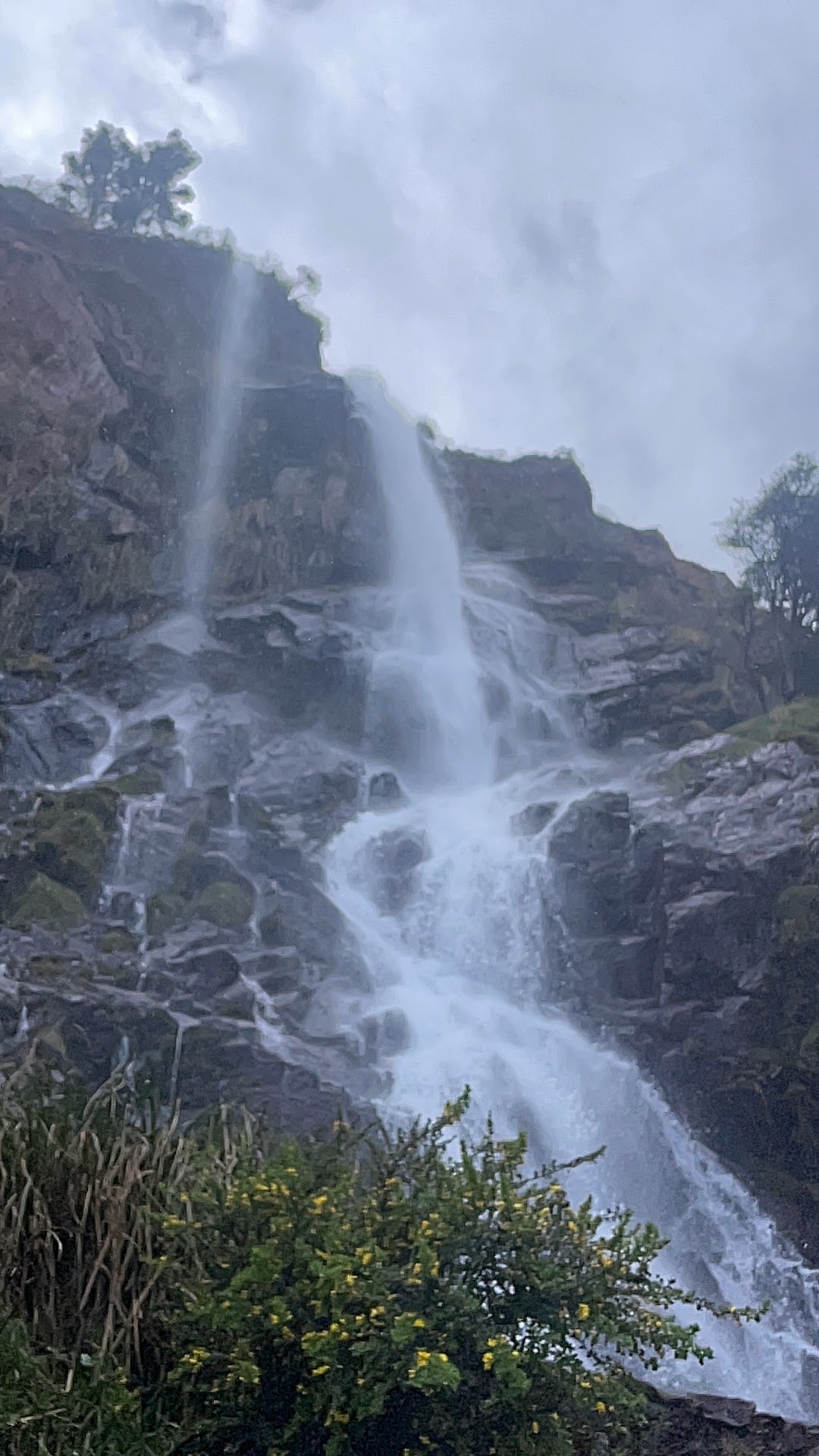 Waterfall cascading over rocky cliffs, symbolizing healing after addiction and personal growth in recovery.